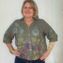 Lady showing detail on Italian linen floral top.