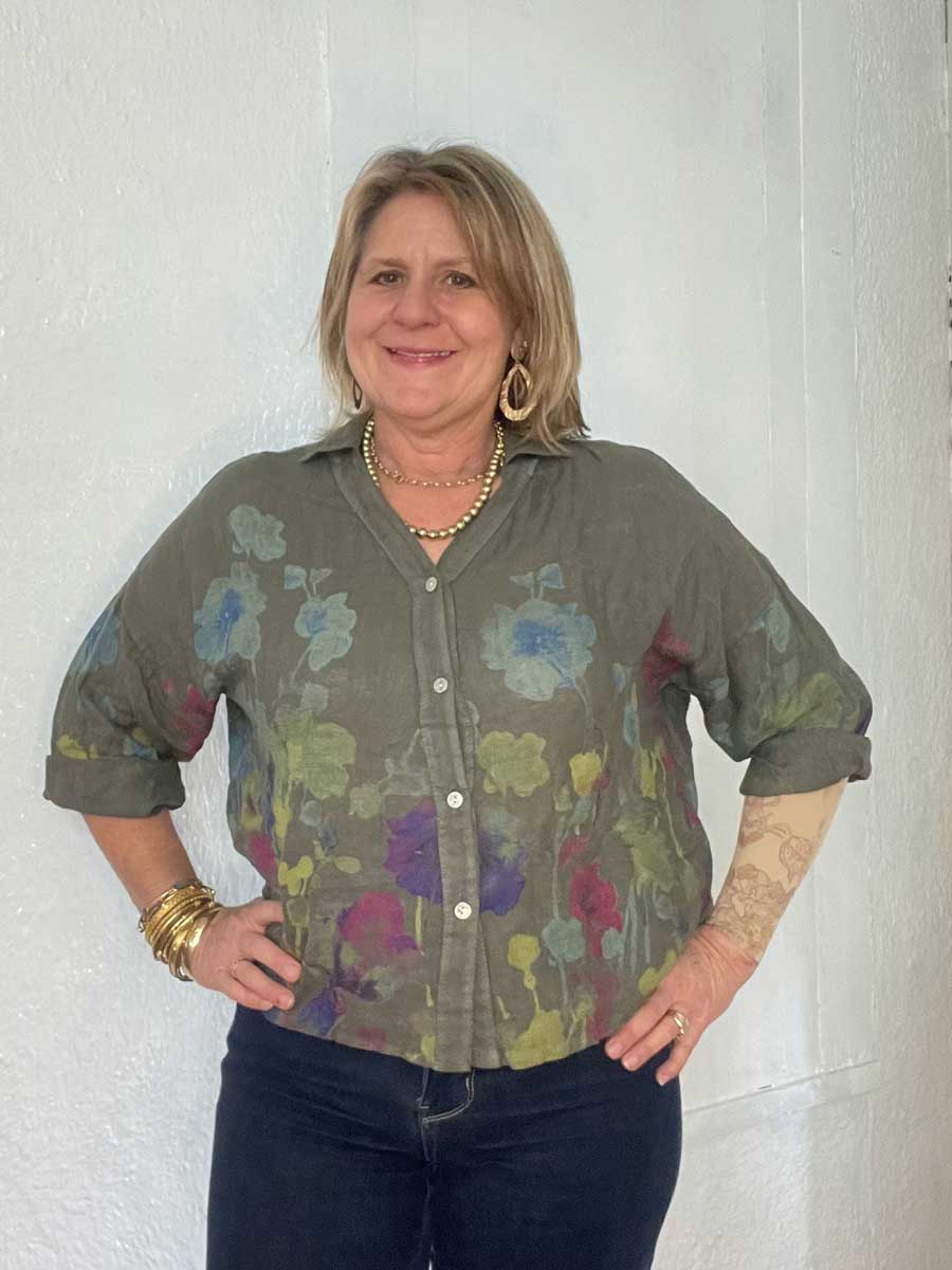 buttonup-watercolor-linen-top-avocado Lady showing detail on Italian linen floral top.