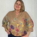 Lady wearing tan colored Italian linen floral top.