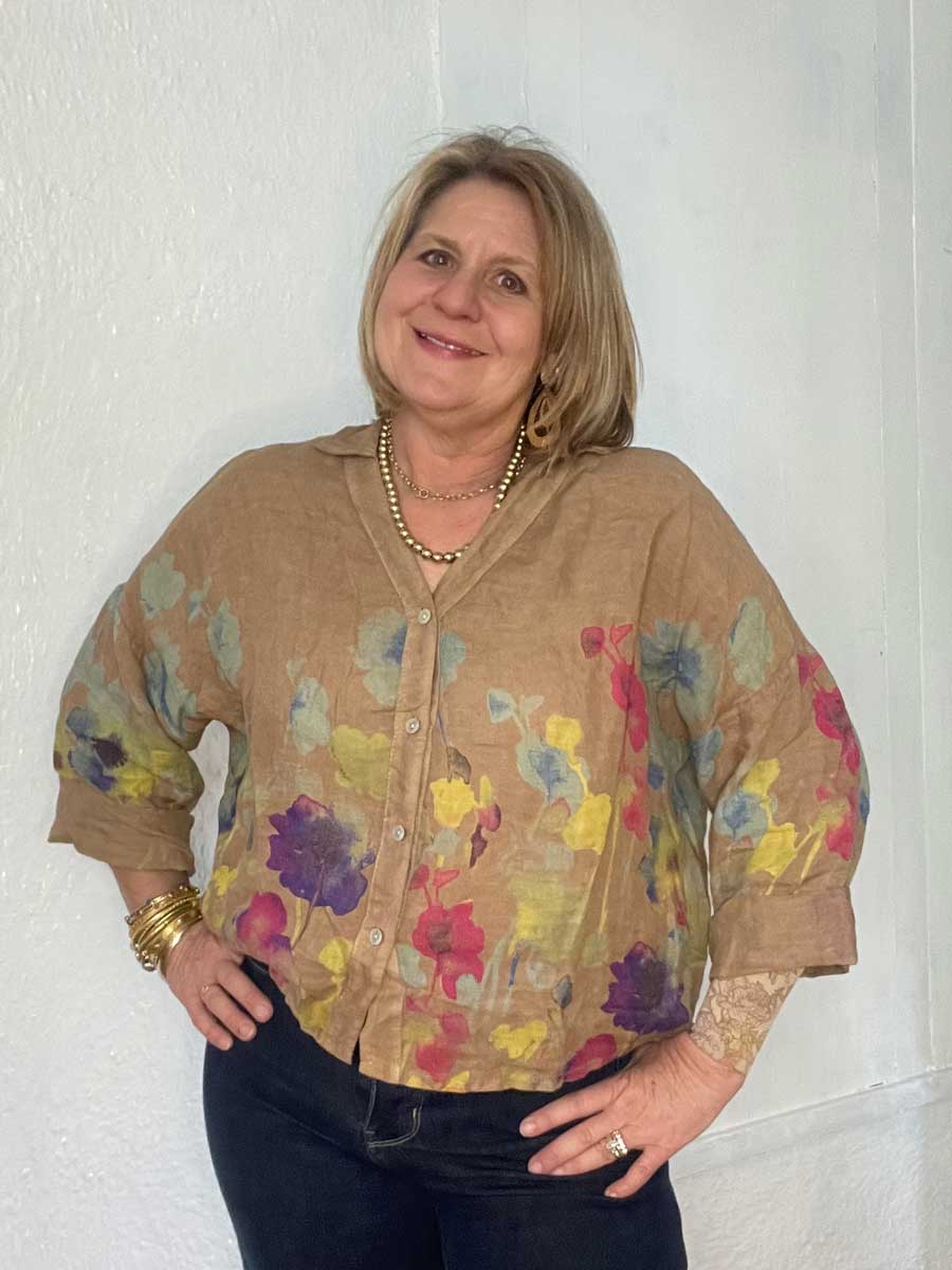 buttonup-watercolor-linen-top-camel Lady wearing tan colored Italian linen floral top.
