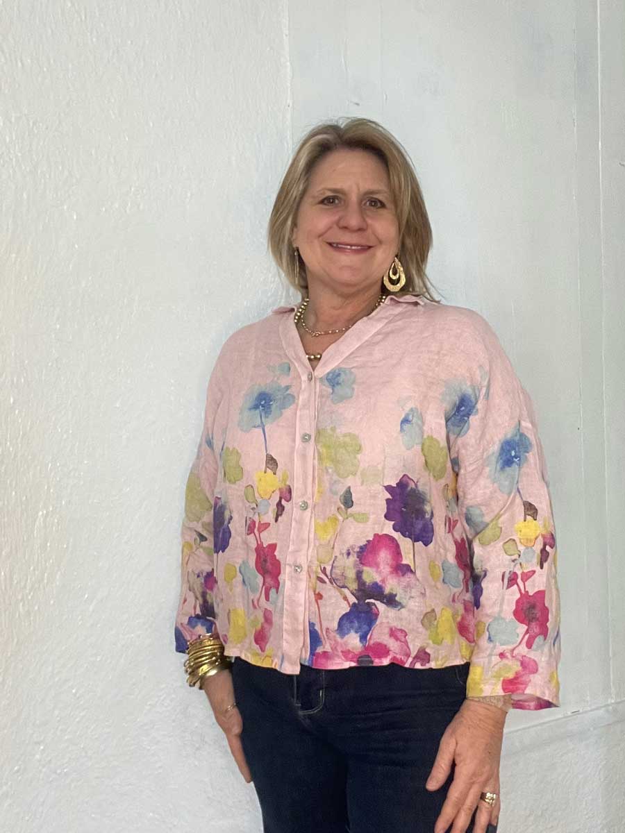 buttonup-watercolor-linen-top-light-pink Lady showing sleeve detail on Italian linen floral top.