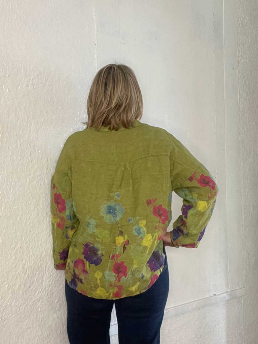 buttonup-watercolor-linen-top-moss-green-back Lady showing back detail of Italian linen floral top.